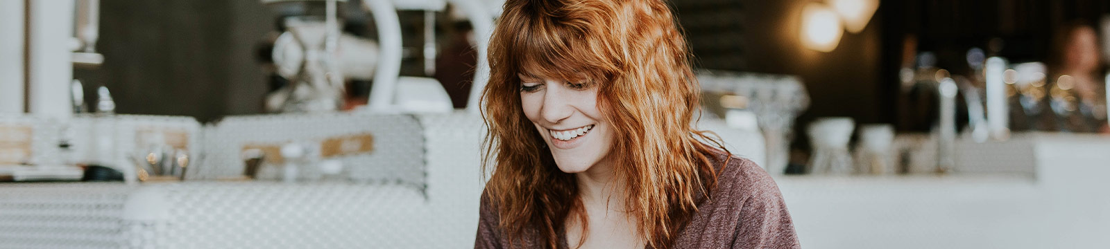 Girl sitting inside a coffee shop.
